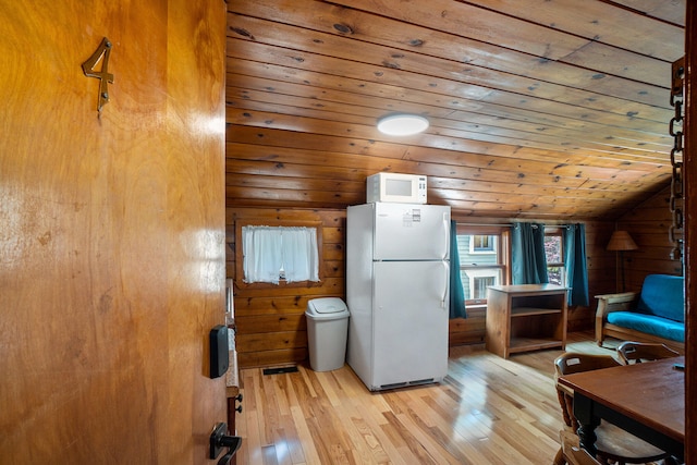 kitchen with wooden ceiling, light hardwood / wood-style flooring, wood walls, lofted ceiling, and white appliances