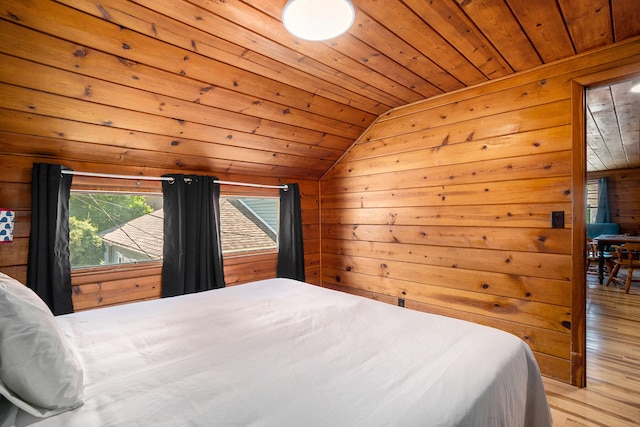 bedroom with wooden ceiling, light hardwood / wood-style floors, lofted ceiling, and wood walls