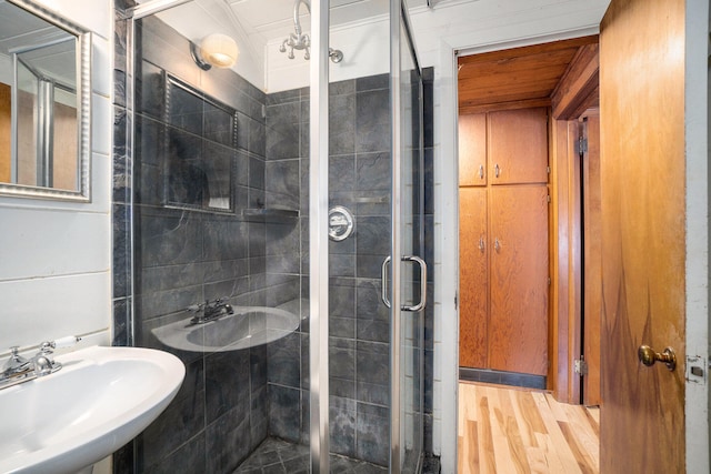 bathroom featuring wood-type flooring, sink, and walk in shower