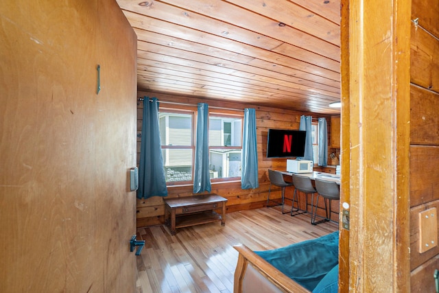 office space with hardwood / wood-style floors, wood ceiling, and wood walls