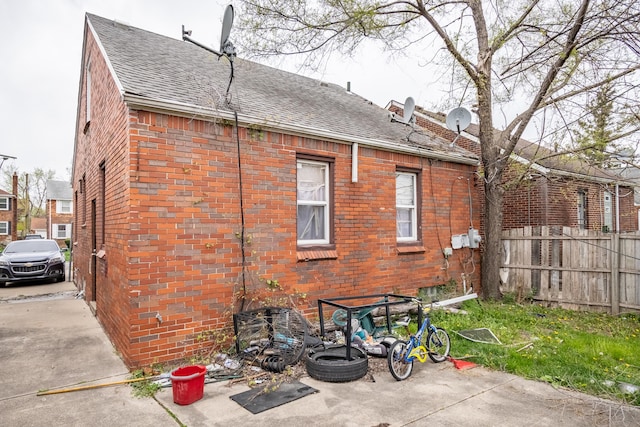 8594 Lauder St, Detroit, MI 48228 - rear view of property featuring brick siding and a shingled roof