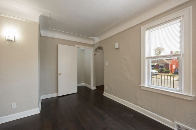 spare room featuring dark hardwood / wood-style floors