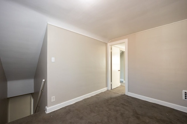 unfurnished room featuring lofted ceiling and carpet floors