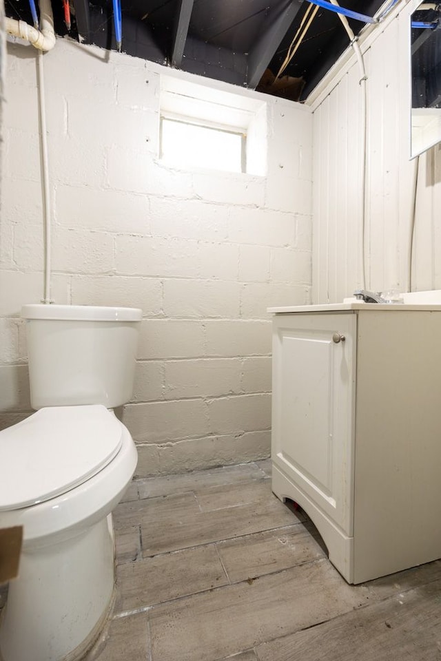 bathroom featuring hardwood / wood-style flooring and toilet