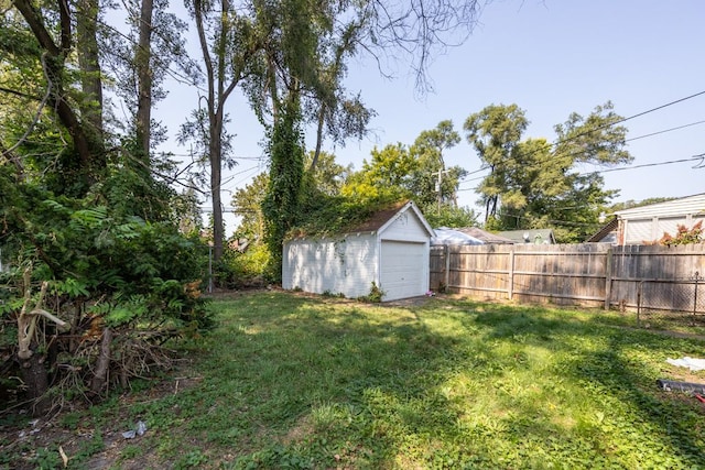 view of yard featuring an outbuilding and a garage