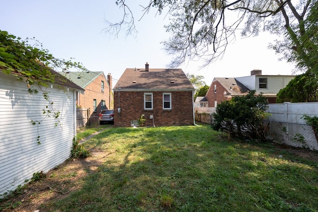 rear view of property with a lawn