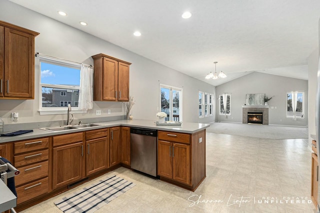 kitchen featuring dishwasher, sink, kitchen peninsula, decorative light fixtures, and vaulted ceiling