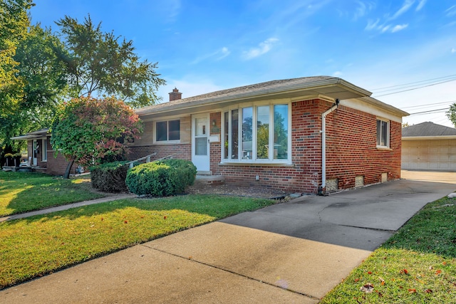 view of front of property featuring a garage and a front lawn