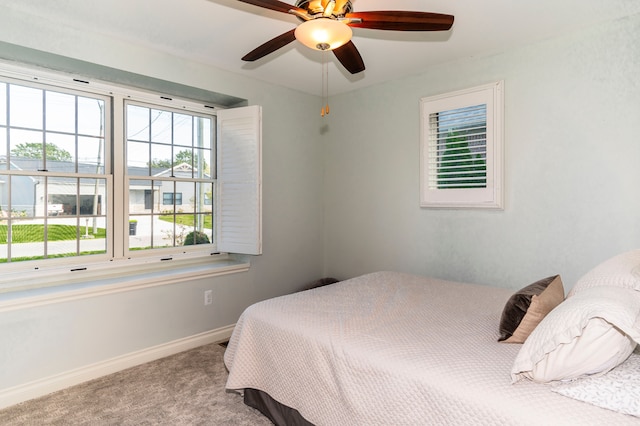 bedroom with baseboards, carpet flooring, and ceiling fan