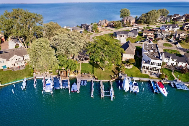 birds eye view of property with a water view and a residential view