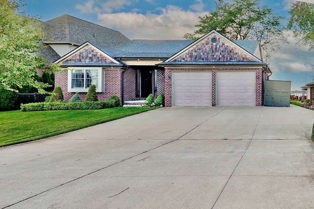 view of front of home with brick siding, driveway, an attached garage, and a front lawn
