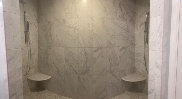 full bath featuring a marble finish shower