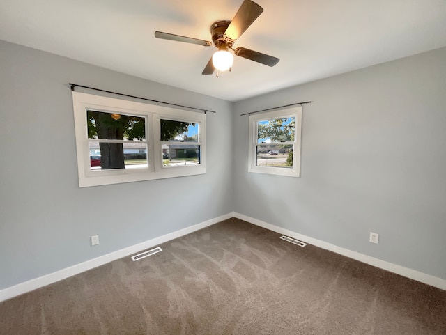 carpeted empty room featuring ceiling fan