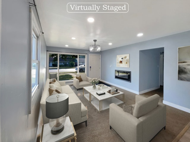 living room with carpet and a chandelier