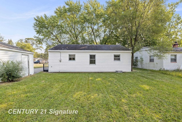 back of house with a lawn