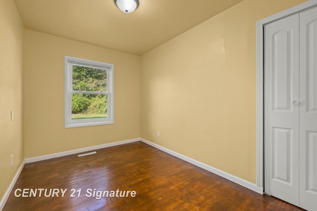 spare room featuring dark hardwood / wood-style floors