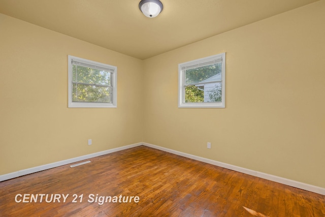 spare room with wood-type flooring