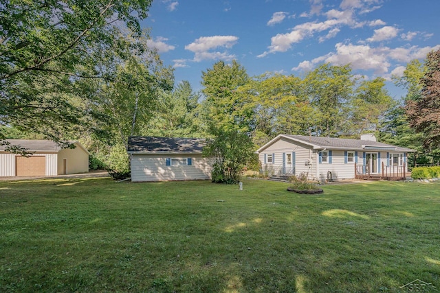 view of yard featuring an outbuilding and a garage