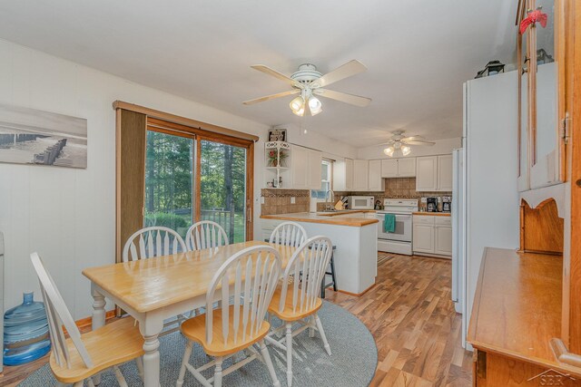 dining space featuring ceiling fan and light hardwood / wood-style floors