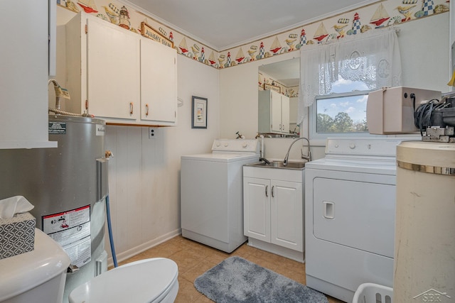 laundry area featuring water heater, washer and clothes dryer, light tile patterned floors, and sink