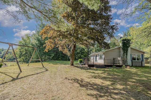 view of yard with a playground and a deck