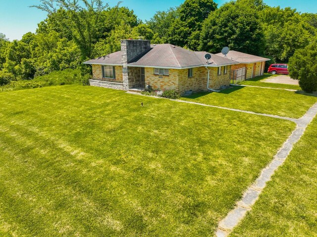 1023 Turrill Rd, Lapeer, MI 48446 - ranch-style house with a chimney, a front lawn, a garage, and driveway