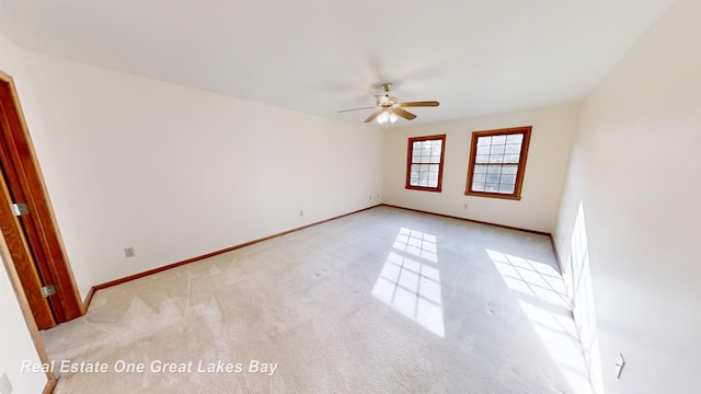 empty room featuring light carpet and ceiling fan