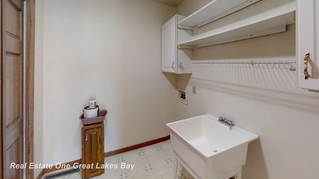 clothes washing area featuring hookup for a washing machine and sink