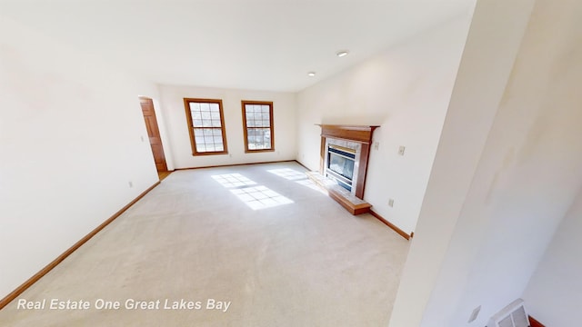 unfurnished living room featuring a fireplace and light carpet