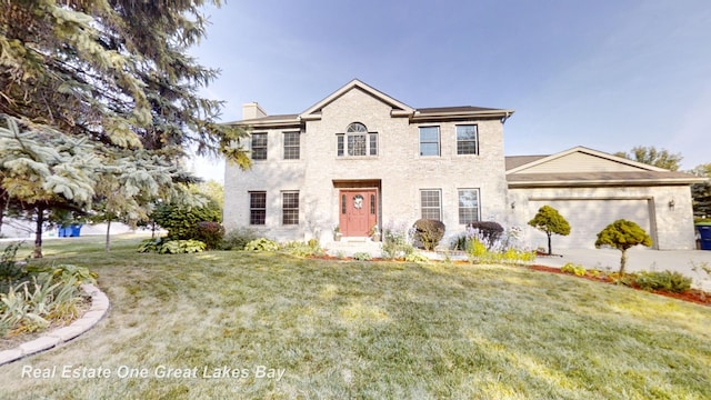 view of front of property featuring a garage and a front yard