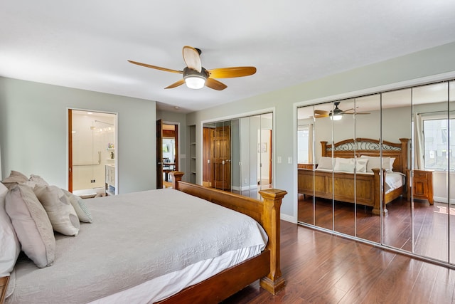 bedroom featuring two closets, ceiling fan, and dark hardwood / wood-style floors