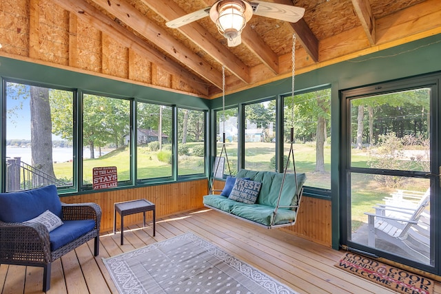 sunroom featuring lofted ceiling with beams, a water view, and ceiling fan