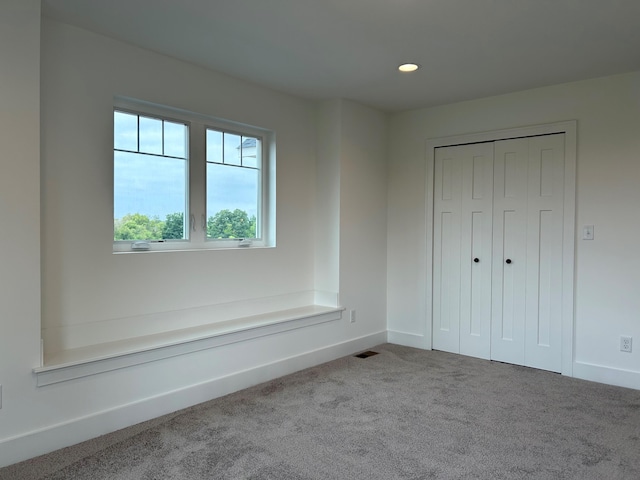 unfurnished bedroom featuring a closet and carpet floors