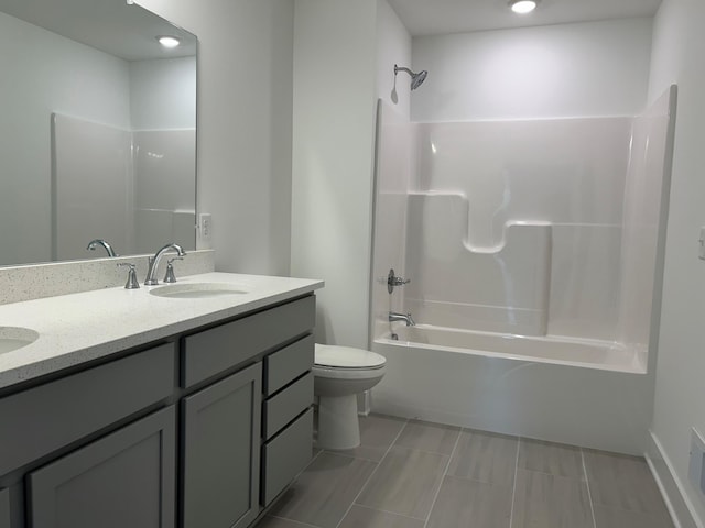 full bathroom featuring bathing tub / shower combination, vanity, and toilet