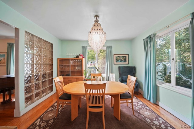 dining area featuring a notable chandelier and hardwood / wood-style flooring