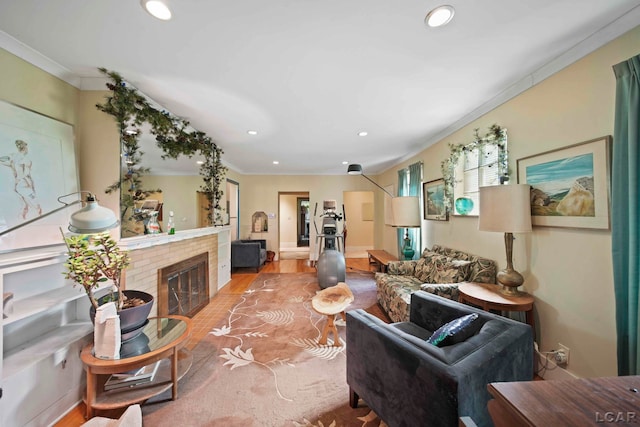 living room with crown molding, wood-type flooring, and a brick fireplace