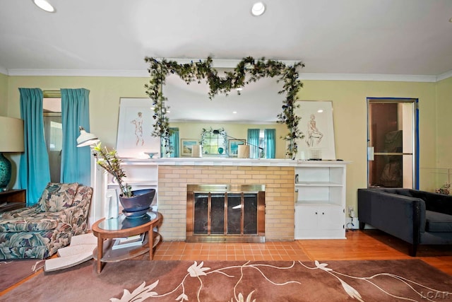 living room featuring a fireplace, hardwood / wood-style floors, and crown molding