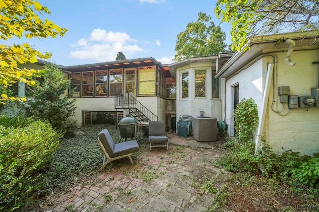 back of house featuring a sunroom, a patio area, and central air condition unit