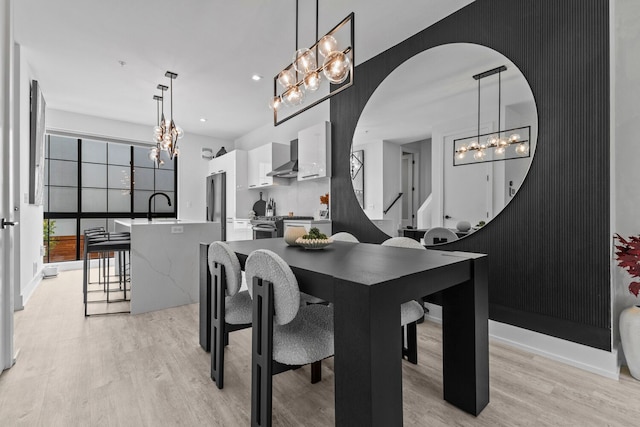 dining space featuring sink and light hardwood / wood-style flooring