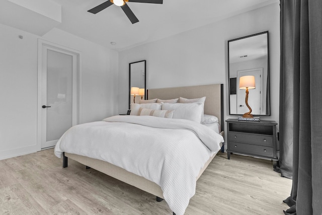 bedroom with light hardwood / wood-style floors and ceiling fan