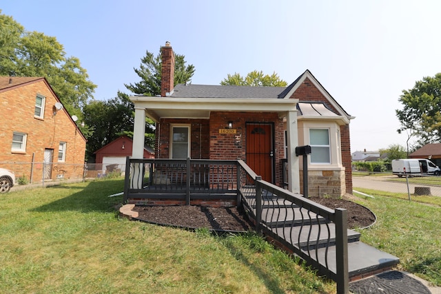 view of front of property with a front yard and a porch