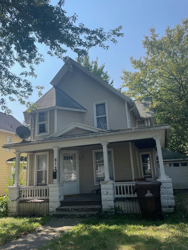 view of front facade with covered porch and a garage