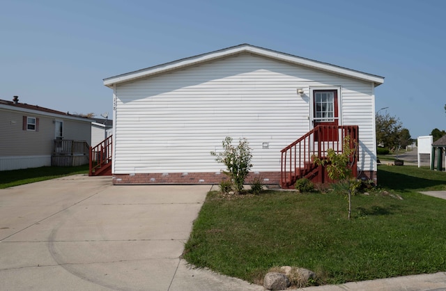 view of property exterior with a yard