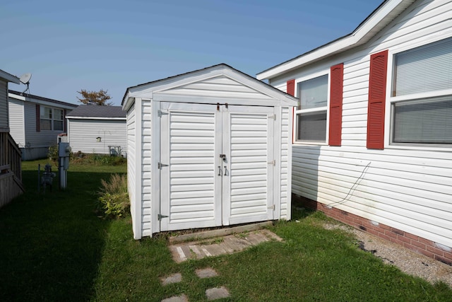 view of outbuilding with a lawn