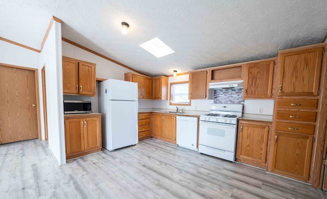 kitchen featuring a textured ceiling, white appliances, light hardwood / wood-style floors, and crown molding