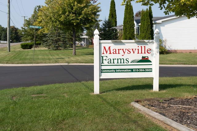 community / neighborhood sign with a lawn