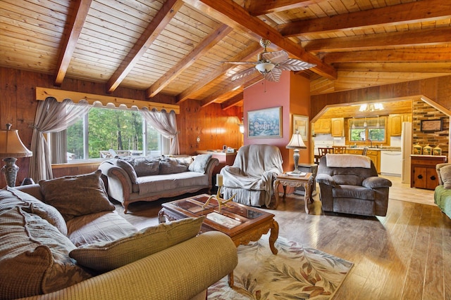 living room with wood walls, wooden ceiling, lofted ceiling with beams, ceiling fan, and light hardwood / wood-style floors