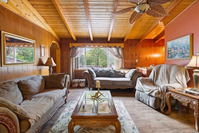 living room with wood walls, hardwood / wood-style flooring, vaulted ceiling with beams, ceiling fan, and wood ceiling