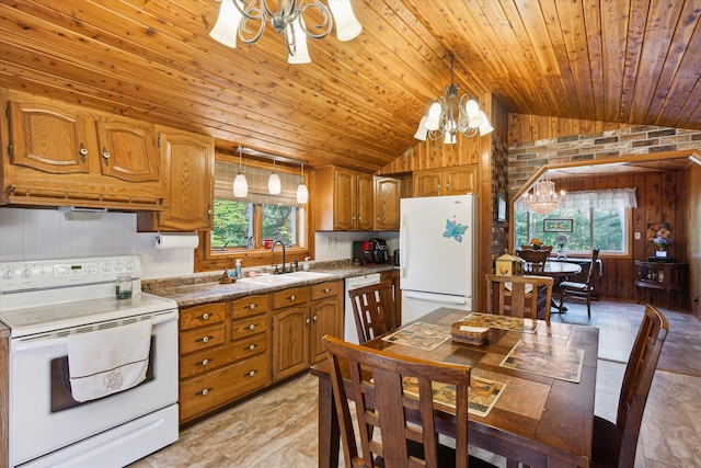 kitchen with a chandelier, white appliances, plenty of natural light, and sink