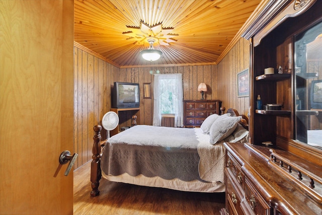 bedroom featuring ornamental molding, vaulted ceiling, hardwood / wood-style flooring, wooden ceiling, and wood walls